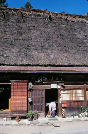 Shirakawa, Japan. An o-baachan cleaning her gassho house